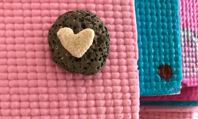 A heart-shaped rock on yoga mats